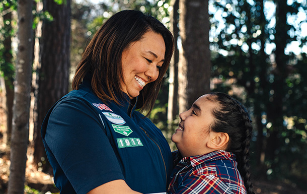 adult volunteer in vest with girl